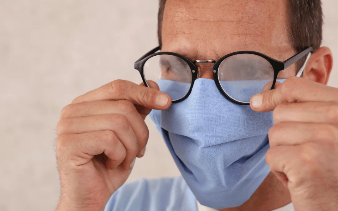 Man Holding A Fogged Blurred Glasses While Wearing Face Mask