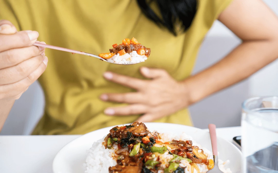 Woman Feeling Discomfort And Pain In The Stomach While Eating A Plate Of Oily Food