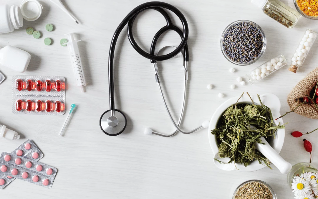 different types and colour of western medications and injections needles syringe arranged on left side with stethoscope in the middle and herbal supplements with dried flowers leaves arranged at the right