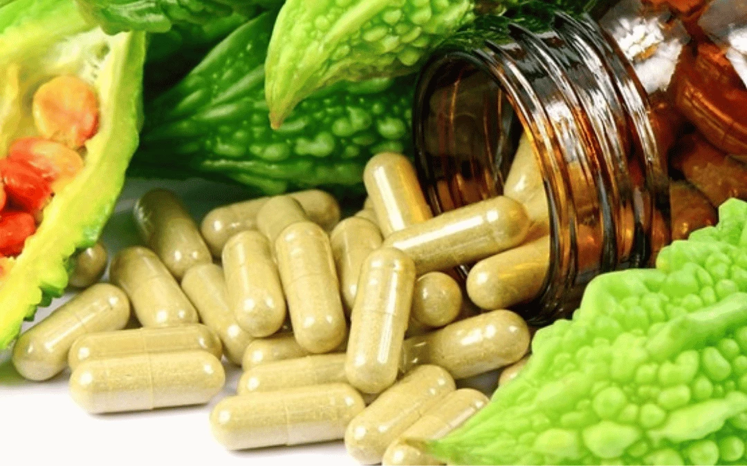 A Close Up Of An Opened Bottle Pouring Out Supplement Capsules In Greenish Brown Colour Surrounded With Bitter Melon Guard