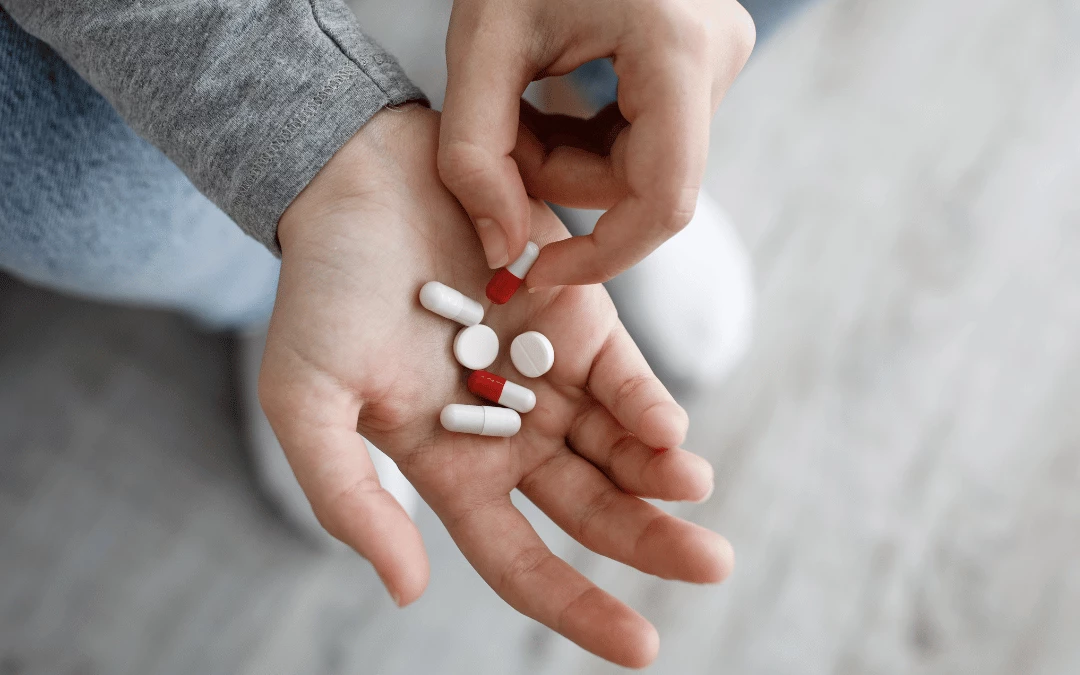 Up Close Of A Palm Holding Six Pills Medication